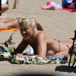 Sarah Connor Flashes Her Nude Breasts on the Beach (9 Photos)